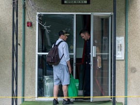 A police officer speaks to a person at an apartment at 10556 80 Avenue on Saturday, Aug. 5, 2023 in Edmonton. People living across the street saw a body being removed from the building earlier today. Greg Southam-Postmedia