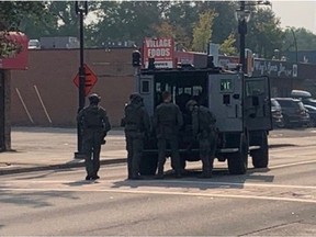 Edmonton police closed 118 Avenue at 85 Street around 5:30 p.m. Thursday, Aug. 24, 2023, as a tactical unit with an armoured vehicle responded to a call. Officers, some of whom carried carbines, could be seen entering and exiting the stairs to a suite above Ming Kee sports bar. The parking lot of an adjacent convenience store was also briefly taped off. Police reopened the avenue to traffic a short time later.