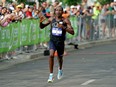 Kip Kangogo, from Lethbridge, Alberta, races to the finish line to win the men's elite division with a time of 2 hours, 23 minutes, 23 seconds at the 2022 Servus Edmonton Marathon held in downtown Edmonton on Sunday August 21, 2022.