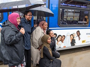 The women behind the campaign pose with an advertisement on the side of a bus. 'Muslim Women Tell it Like it Is' campaign launch, at Commonwealth LRT station where a city-wide ad campaign will be unveiled to the public. Members of Sisters Dialogue will be available to discuss the campaign and why it's important after the lingering impact of hate attacks against Muslim women in Edmonton on August 18, 2023.