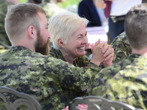Brigadier-General Jennie Carignan of the Canadian Armed Forces joins soldiers during a lunch with Prime Minister Justin Trudeau and Secretary General of the North Atlantic Treaty Organization (NATO) Jens Stoltenberg at Canadian Forces Base Petawawa, Ont. on July 15, 2019. The military's chief of professional conduct and culture says the Armed Forces will end its "inflexible and inhuman" mandatory reporting policy. Lt.-Gen. Jennie Carignan says members will still be able to report misconduct but they will no longer face possible penalties for failing to report something they experience or witness.