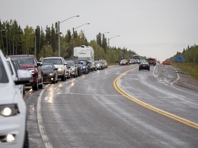 Evacuees from Yellowknife queue up to get gas at Big River Service in Ft. Providence, N.W.T., Thursday, Aug. 17, 2023.