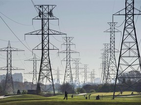 Statistics Canada says volatility in the amount Albertans paid for electricity last month helped slow the decline of Canadian energy prices for July -- one of the key reasons cited by the agency as the national inflation rate ticked up.Hydro towers are seen over a golf course in Toronto on Wednesday, Nov. 4, 2015.