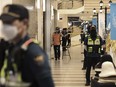 Police officers cordon off the scene of a stabbing rampage near a subway station in Seongnam, South Korea, Thursday, Aug. 3, 2023. A dozen of people were injured in South Korea on Thursday when a man rammed a car onto a sidewalk and then stepped out of the vehicle and began stabbing people near a subway station in the city of Seongnam.