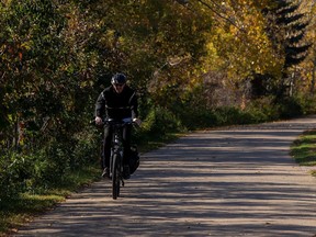 A cyclist takes advantage of the warm weather as he pedals in the North Saskatchewan River valley on Oct. 4, 2022, in Edmonton.
