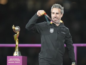 Spain's head coach Jorge Vilda shows his gold medal after winning the Women's World Cup soccer final against England at Stadium Australia in Sydney, Australia, Sunday, Aug. 20, 2023.