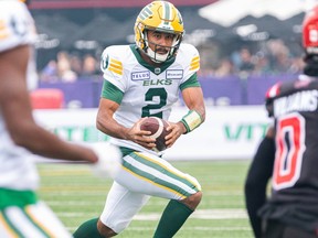 Edmonton Elks quarterback Tre Ford runs with the ball against Calgary Stampeders during the first half of the Labour Day Classic at McMahon Stadium on Monday, Sept. 4, 2023.