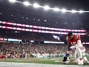 Ezekiel Elliott #15 of the New England Patriots kneels prior to a game amia at Gillette Stadium on September 17, 2023 in Foxborough, Massachusetts.