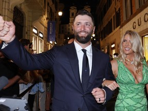 Jon Rahm of Team Europe and his wife Kelley Cahill walk through fans at the Spanish Steps prior to the 2023 Ryder Cup at Marco Simone Golf Club on Wednesday in Rome, Italy..