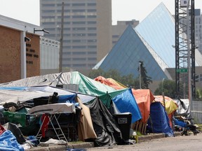 City Hall is visible in the background at a homeless encampment along 100 Street near 105A Ave., in Edmonton Thursday, July 6, 2023.