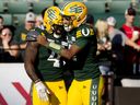 Edmonton Elks running back Kevin Brown (4) and quarterback Tre Ford (2) celebrate a touchdown against the Calgary Stampeders at Commonwealth Stadium in Edmonton on Saturday, Sept. 9, 2023.