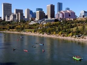 Downtown Edmonton is visible in the background as a large group of canoes and rafts make their way down the North Saskatchewan River, Friday, Sept. 15, 2023. Photo by David Bloom