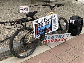 A sign in the distance advertises a protest planned for next Wednesday in Ottawa.