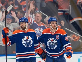 Evan Bouchard (2) and Connor McDavid (97) of the Edmonton Oilers celebrate after the second goal against the Las Vegas Golden Knights in Game 4 of the second round of the NHL playoffs at Rogers Place in Edmonton on May 10, 2023.