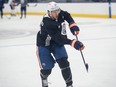 Vincent Desharnais in Oilers practice gear shoots a puck