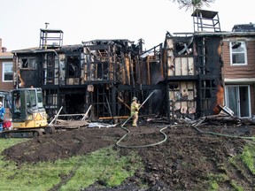 Two overnight fires displaced families in at least three townhouses on Hooke Road. Fire crews remained on scene dowsing hot spots on August 29, 2023.