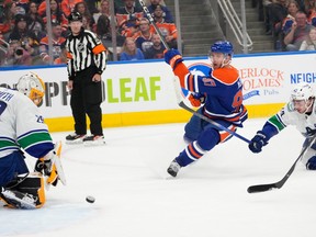 Edmonton Oilers Connor McDavid (97) shoots the puck past Vancouver Canucks goalie Casey DeSmith