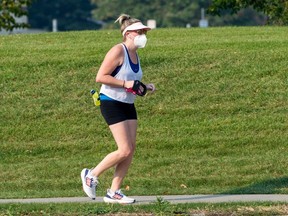 A runner wears a KN95 mask as the air quality index is a 10+ which is very high risk on Saturday, Sept. 16, 2023, in Edmonton. Greg Southam-Postmedia