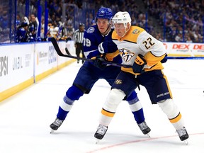 Tyson Barrie of the Nashville Predators and Waltteri Merela of the Tampa Bay Lightning fight for the puck.