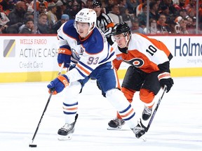 Ryan Nugent-Hopkins #93 of the Edmonton Oilers skates with the puck past Bobby Brink #10 of the Philadelphia Flyers during the third period at the Wells Fargo Center on October 19, 2023 in Philadelphia, Pennsylvania.