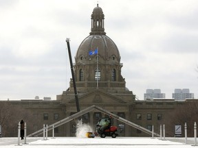 The Alberta Legislature is visible in the background as crews clear snow from Violet King Henry Plaza, in Edmonton Thursday Oct. 26, 2023.