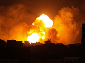 Fire and smoke rise above buildings in Gaza City during an Israeli air strike, on October 8, 2023.