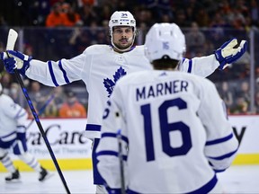 Maple Leafs' Auston Matthews (left) celebrates with teammate Mitch Marner after scoring past Philadelphia Flyers goaltender Carter Hart during a game on Saturday, April 2, 2022, in Philadelphia.