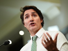 Justin Trudeau wearing shirt and tie gestures while speaking