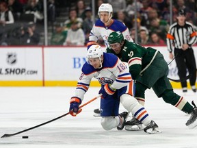 Edmonton Oilers left wing Zach Hyman (18) and Minnesota Wild center Vinni Lettieri vie for the puck during the second period of an NHL hockey game Tuesday, Oct. 24, 2023, in St. Paul, Minn. Abbie Parr/AP Photo