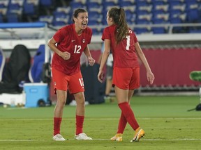 Canada's Christine Sinclair (right) celebrates with Julia Grosso, who scored the winning penalty kick goal against Sweden, during the women's soccer gold medal game at the Tokyo Olympics in Yokohama, Japan on Aug. 6, 2021. The star Canadian soccer player has announced her retirement.