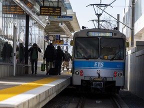 Passengers board an LRT car on an outdoor platform