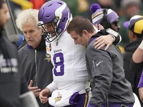 Minnesota Vikings quarterback Kirk Cousins is helped off the field after going down with an injury in the fourth quarter of an NFL game against the Green Bay Packers on Sunday, Oct. 29, 2023, in Green Bay, Wis.