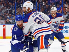 Edmonton Oilers defenceman Darnell Nurse hits Luke Glendening during the second period at Amalie Arena on Saturday, Nov.18.