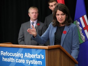 Alberta Premier Danielle Smith stands behind a podium with the words "Refocusing Alberta's health care system"