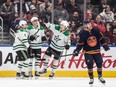 Dallas Stars Miro Heiskanen (4), Roope Hintz (24) and Jason Robertson (21) celebrate a goal as Edmonton Oilers forward Derek Ryan (10) skates by in Edmonton on Thursday, Nov. 2, 2023.