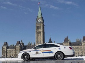 An RCMP police car sits outside the Parliament buildings on Parliament Hill in Ottawa on February 6, 2015.