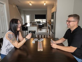 Crystal Shepley and Jared Peacock play cribbage in their new Stellar home by Sterling Homes in Rivers Edge.