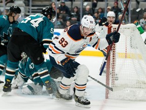 Ryan Nugent-Hopkins celebrates a goal as behind him a group of San Jose players fish the puch out of their net