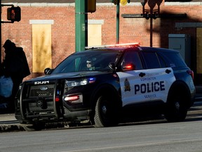 Police officers work along 101 Street at 107 Avenue in Edmonton on Monday, Jan. 01, 2024. A stabbing occurred near the intersection on Sunday, Dec. 31, 2023.