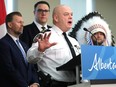 Edmonton Police Chief Dale McFee speaks at a podium with provincial and First Nations representatives in the background