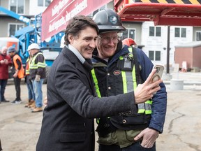 PM Justin Trudeau takes a selfie with a construction worker