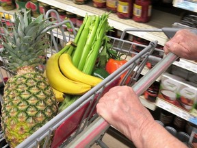 A shopping cart is seen in a grocery aisle.