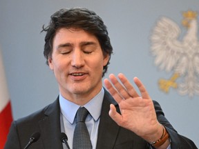 Prime Minister Justin Trudeau reacts during a joint press conference with Poland's prime minister in Warsaw on Feb. 26, 2024.