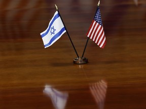 The flags of Israel and the United States are seen as U.S. Secretary of Defense Lloyd Austin speaks during a meeting with Israeli Minister of Defense Yoav Gallant at the Pentagon on March 26, 2024 in Arlington, Virginia.