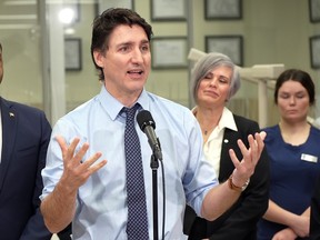 Justin Trudeau stands at a microphone