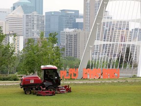 Crews mow the grass near a 'Play Bamba Baby' sign in Edmonton's Kinsmen Park, Tuesday June 7, 2022. The Edmonton Oilers lost the NHL Western Conference Final to the Colorado Avalanche Monday night. Photo By David Bloom