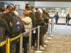Citizens line up for a variety of subsidized City of Calgary services, including a low-income transit pass at the Municipal Building in downtown Calgary on Tuesday.