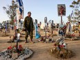 An Israeli soldier visits a memorial bearing portraits of people taken hostage or killed in the Hamas attack on the Supernova music festival on October 7, at the site of the festival near Kibbutz Reim in southern Israel, on May 9, 2024.