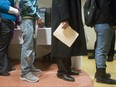 People line up at an Employment Ontario job fair in London, Ont., on Wednesday, Feb.15, 2012.