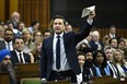 Conservative Leader Pierre Poilievre waves a document in the air as he rises during Question Period in the House of Commons on Parliament Hill in Ottawa on Wednesday, June 5, 2024.